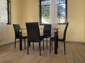 Enjoy meals in this dining area with a glass-top table and four comfortable chairs.