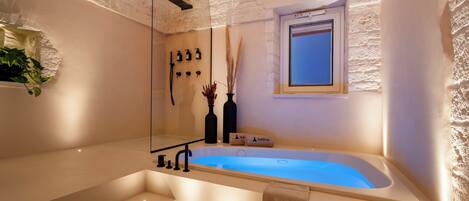 Luxury Suite, 1 King Bed | Bathroom | Separate tub and shower, jetted tub, rainfall showerhead