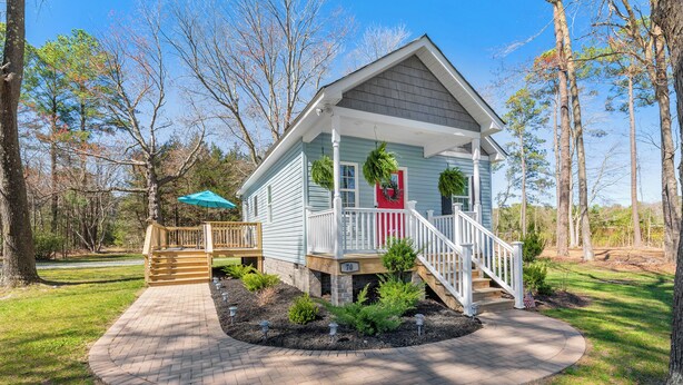 A small, single-story house with a porch, a wooden deck, and a brick pathway. - Deltaville 2BR Retreat, Walk to Museum, Boat Parking (Deltaville)