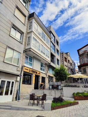 A multi-story building with a pizzeria on the ground floor.