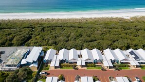 A coastal residential area with modern houses, a beach, and a large ship in the distance. - Your summer Beach Escape is calling (ALBANY)