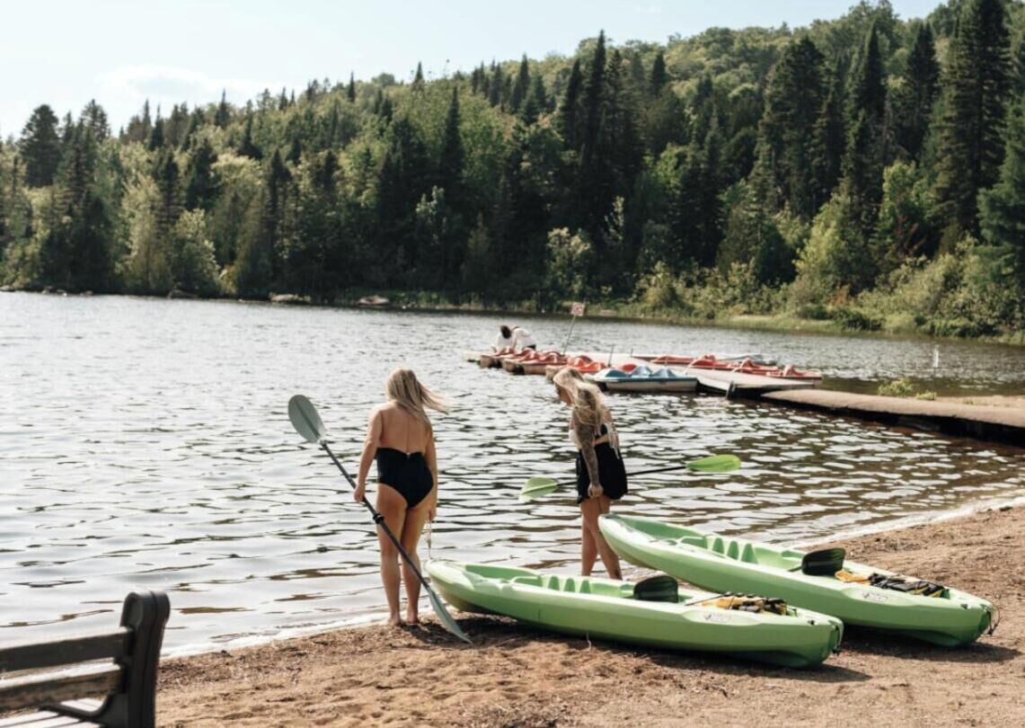 A lake with kayaks and a dock.