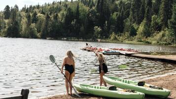 A lake with kayaks and a dock.