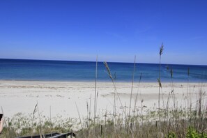 A beach with clear blue water and a sandy shore. - 99 Wing Blvd W (Sandwich)