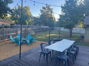 A backyard with a wooden deck, outdoor seating, and a soccer goal. - Game Room + Colorful Comfort (Norman)
