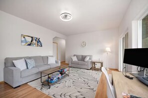 Smart TV, fireplace, books, computer monitors