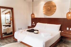 A neatly made bed with white linens, a wooden headboard, and two hanging light fixtures. - Stunning new villa heated pool, 4 bedrooms, walk to Calle 7, outdoor dining (Tulum)