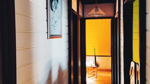A hallway with white walls, a wooden ceiling, and a yellow door at the end. - 3 Bedroom Villa in Le Robert (Le Robert)