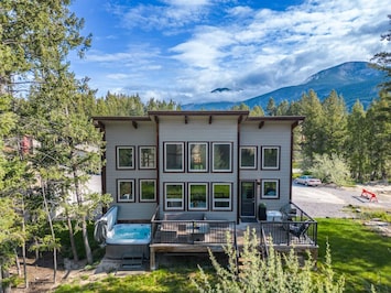 Exterior view of Modern Tides, with a private deck, hot tub & backyard space.