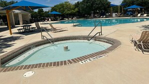 A swimming pool with a brick edge, a shallow end marked '1 FT 6 INCH,' and lounge chairs around the perimeter.