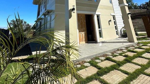 A two-story house with a flat roof, large windows, and a front door. - GREAT PLACE TO STAY (San Nicolas)