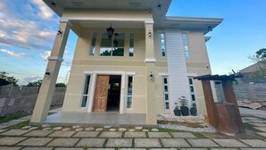 A modern two-story house with a flat roof, large windows, and a front porch. - GREAT PLACE TO STAY (San Nicolas)