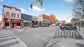 A street intersection with various storefronts, including a bar and a music lounge. - Cozy Studio Retreat one block from Downtown Noblesville. (Noblesville)
