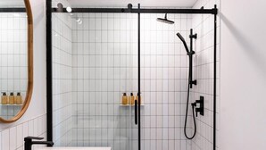 A modern bathroom with a glass-enclosed shower, a white sink, and a mirror. - Maison Place Royale • Luxury Waterfront Two-Bedrooms Apartment • Old Montreal • Water View St. Lawrence River • Full Kitchen • Stone Walls • Wi-Fi • AC (Montréal)