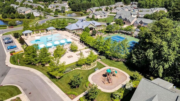 A residential area with houses, a swimming pool, and a tennis court. - Forest Landing Bethany Beach Pool, Kids Mega Room (Frankford)