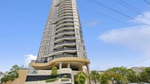 A tall, modern hotel with a curved facade and multiple balconies. - Broadbeach Elegant apartment with views! (Broadbeach)