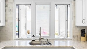 A kitchen with a sink, a window with blinds, and a knife block. - Design Award Winner Scottsdale/Tempe Home POOL HTD

 (Tempe)