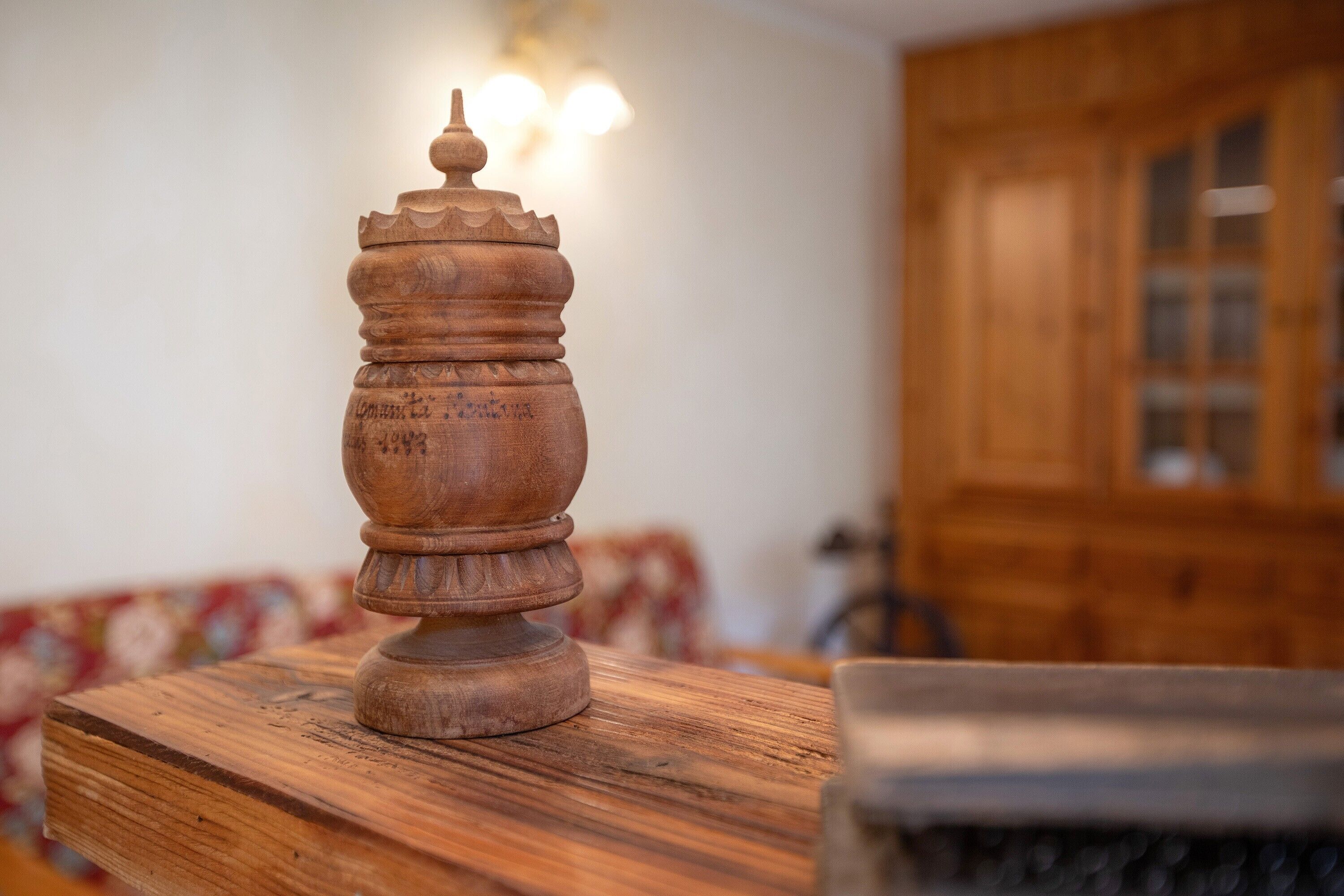 A wooden table with a carved wooden object on it.
