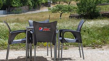 A table with four chairs, each chair has a Pepsi Max logo.