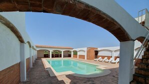 A swimming pool with a tiled deck, white lounge chairs, and a brick pathway. - Country House 'Cal Eloi Janet' with Mountain Views, Private Pool and Wi-Fi (Sant Marti Sarroca)