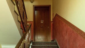 A staircase with a wooden door at the top.