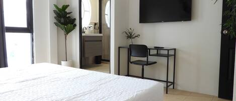 City Room | Desk, laptop workspace, blackout drapes, iron/ironing board