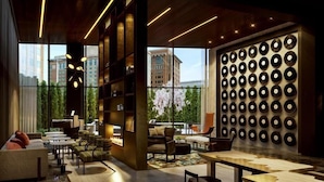 A modern interior with a fireplace, seating area, and a wall of vinyl records.