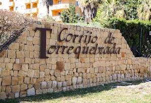 A stone wall with the text 'Corrijo de Torrequebrada' indicating a location or property name. - Luxury 100m² Sea View Apartment with Pool, Wi-Fi & Terrace (Benalmádena)