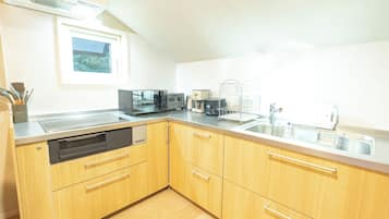 Fridge, microwave, coffee/tea maker, cookware/dishes/utensils