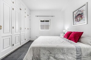 A bedroom with a bed, white wardrobe, and a window. - Holiday Home 'Bright' with Mountain View, Balcony and Wi-Fi (Agaete)