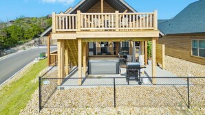 A two-story wooden house with a balcony, a covered patio, and a grill area. - Lake Lookout Retreat with Private Hot Tub, Free Attraction Tickets & Community Pools (Branson)