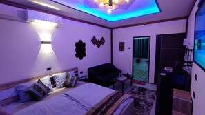Economy Room | Living area | 42-inch flat-screen TV with satellite channels