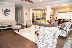 A modern living room with a sofa, armchairs, and a coffee table. - Modern comfort within walking distance from UKY, Kroger Field, & Chevy Chase. (Lexington)