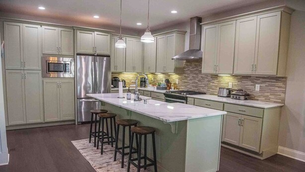 A modern kitchen with a large island, stainless steel appliances, and a neutral color palette. - Modern comfort within walking distance from UKY, Kroger Field, & Chevy Chase. (Lexington)