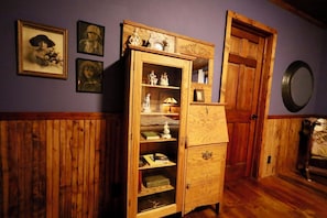 A room with a wooden cabinet against a purple wall, wooden paneling on the walls, and a mirror on the right. - Expect! WOW! Jacuzzi, Game Room, Fire Pit, Waterbed, Massage Chair, Remodel 2024 (Glenwood Springs)