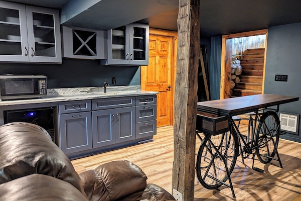 Movie room with wet bar, microwave, beverage fridge, bike bar, OLED TV