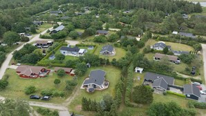 An aerial view of a residential area with houses, roads, and a coastline in the background. - "Ingwin" -  from the sea by Interhome (Hals)