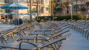 A row of sun loungers with metal frames and no cushions, arranged in a line on a tiled patio area. - Fully renovated in 2025!! (Saint Simons Island)