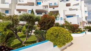 A modern white building with balconies and a well-maintained garden. - Perla Blanca by Interhome (Peñiscola)