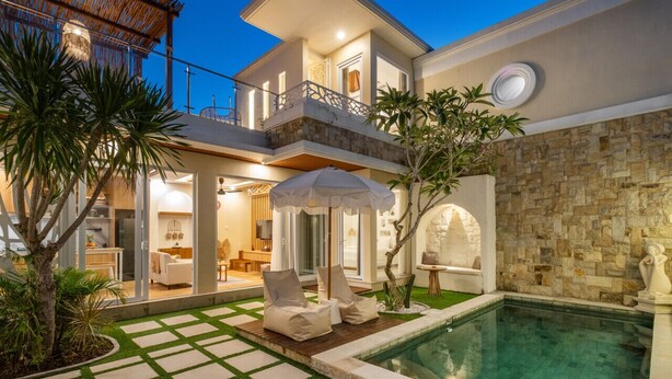 A two-story house with a swimming pool, outdoor seating, and a stone wall. - 2BR Private Pool Villa Dove By Orivista (Mengwi)