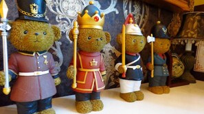 Four teddy bears dressed in military uniforms, each with different insignia, standing against a patterned backdrop. - Venice (Taitung)