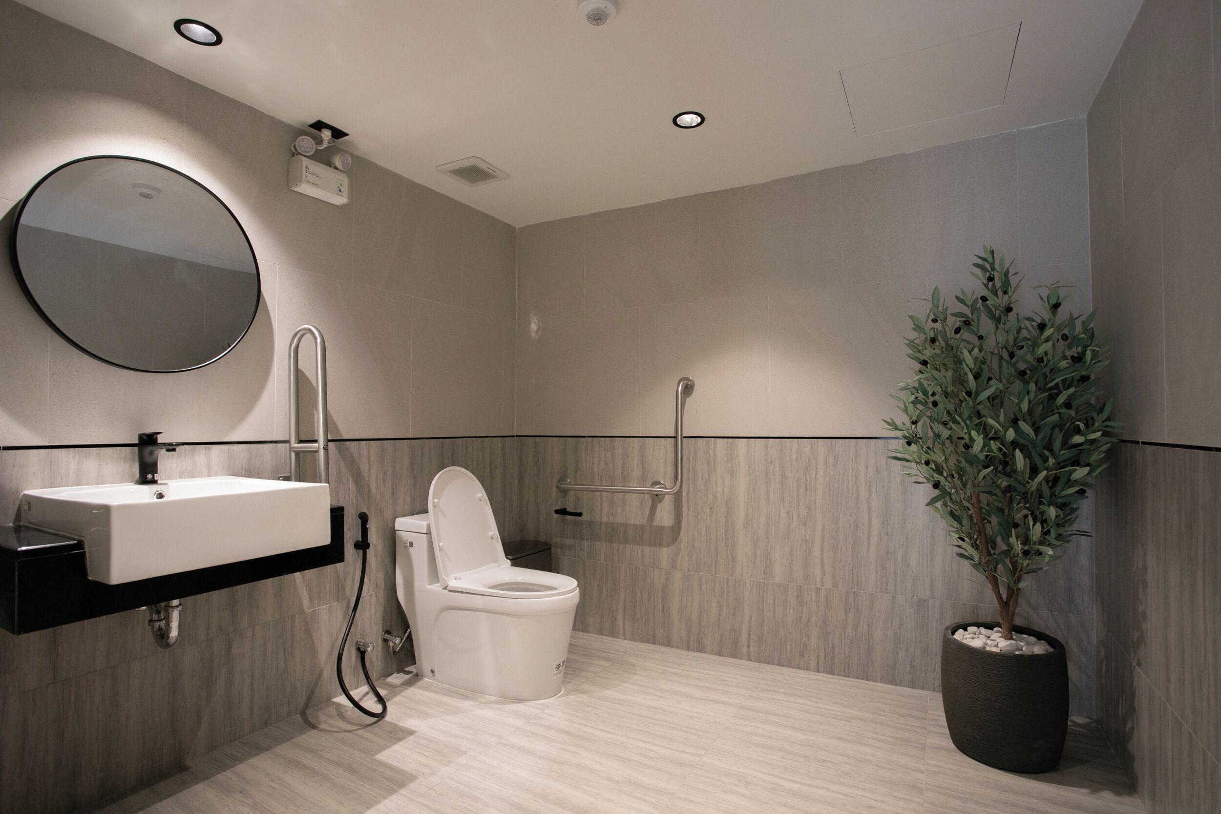 A modern bathroom with a sink, toilet, and shower.