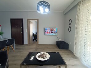 Comfort Apartment, City View | Living area | 49-inch Smart TV with digital channels - Highlighted Retreat (Athens)