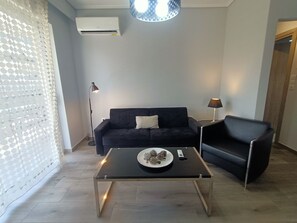Comfort Apartment, City View | Living area | 49-inch Smart TV with digital channels - Highlighted Retreat (Athens)
