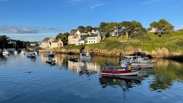 A calm harbor with several boats docked, surrounded by houses and greenery. - Appartement 2pers Le Pouldu, Proche Plages (Clohars-Carnoët)