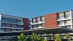 A modern building with the sign "LUKA HOUSE" on the facade. - Luka House (Lam Luk Ka)