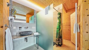 A modern bathroom with a wooden ceiling, a large mirror, a granite countertop, and a shower with a green curtain. - Hotel Müller Café & Wein . Mondholzhotel (Veitshoechheim)
