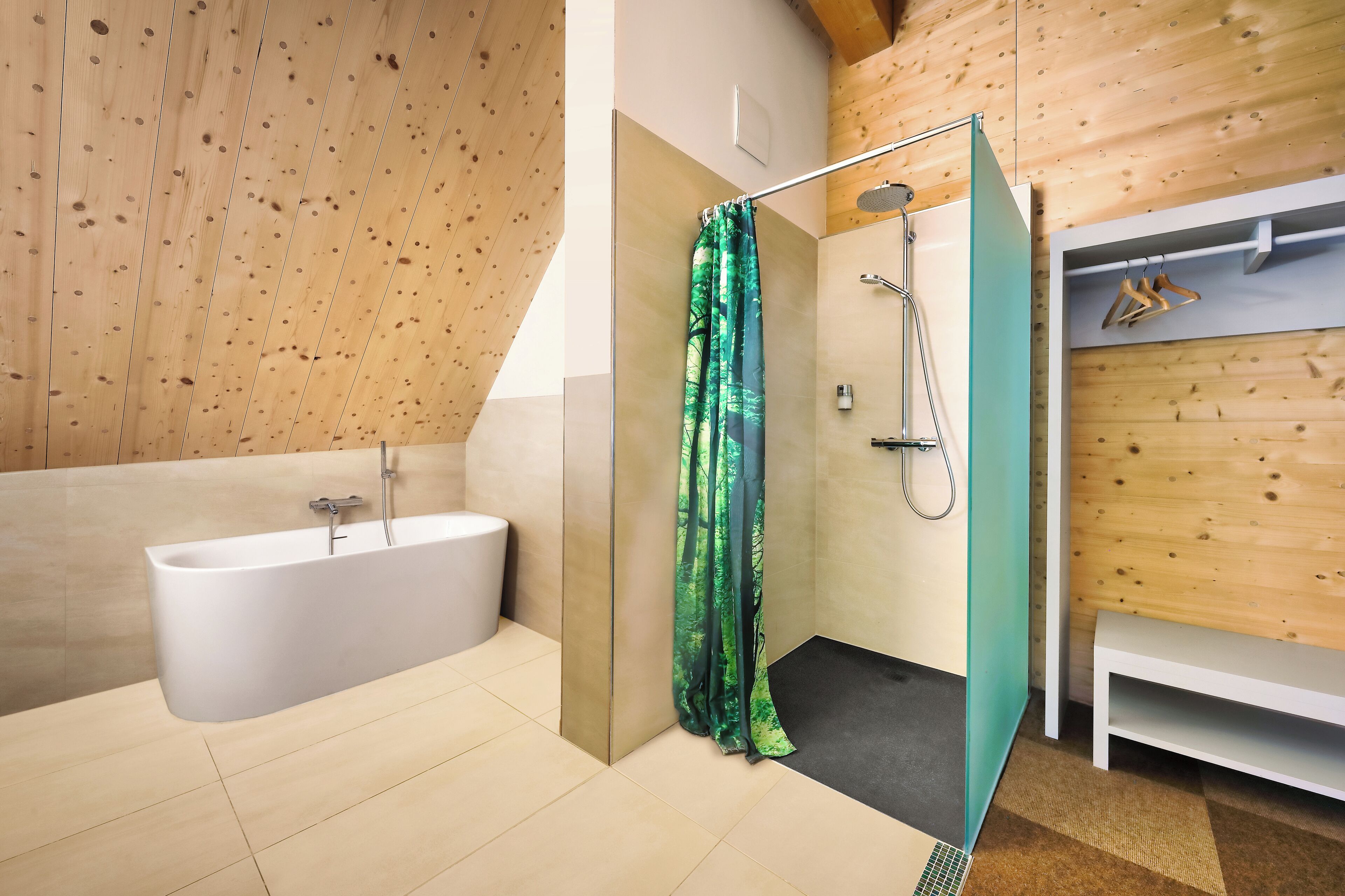 A modern bathroom with a glass-enclosed shower, a freestanding bathtub, and wooden paneling on the walls.