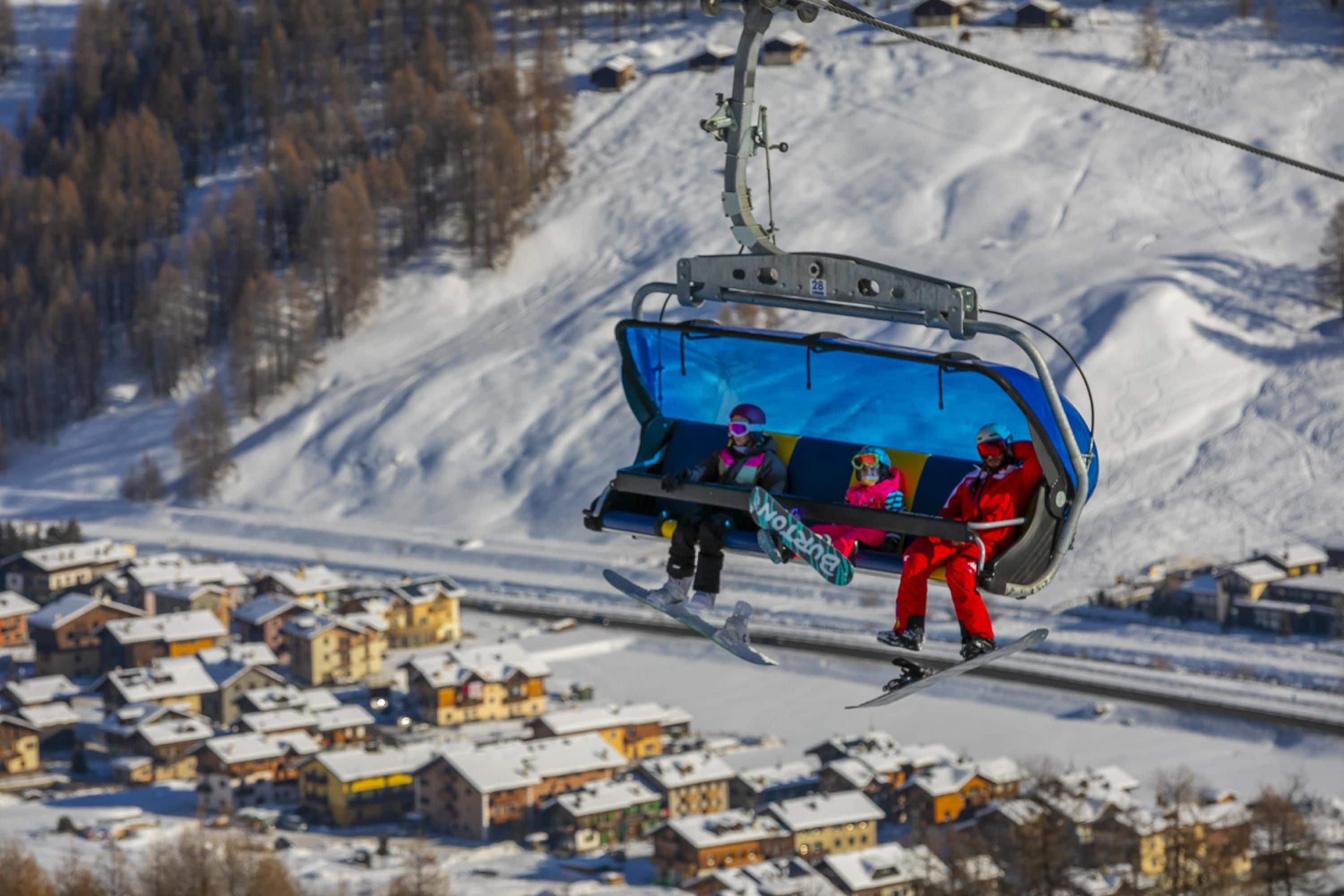 A ski lift with a cabin carrying skiers.