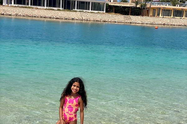 On the beach, white sand, sun-loungers, beach umbrellas